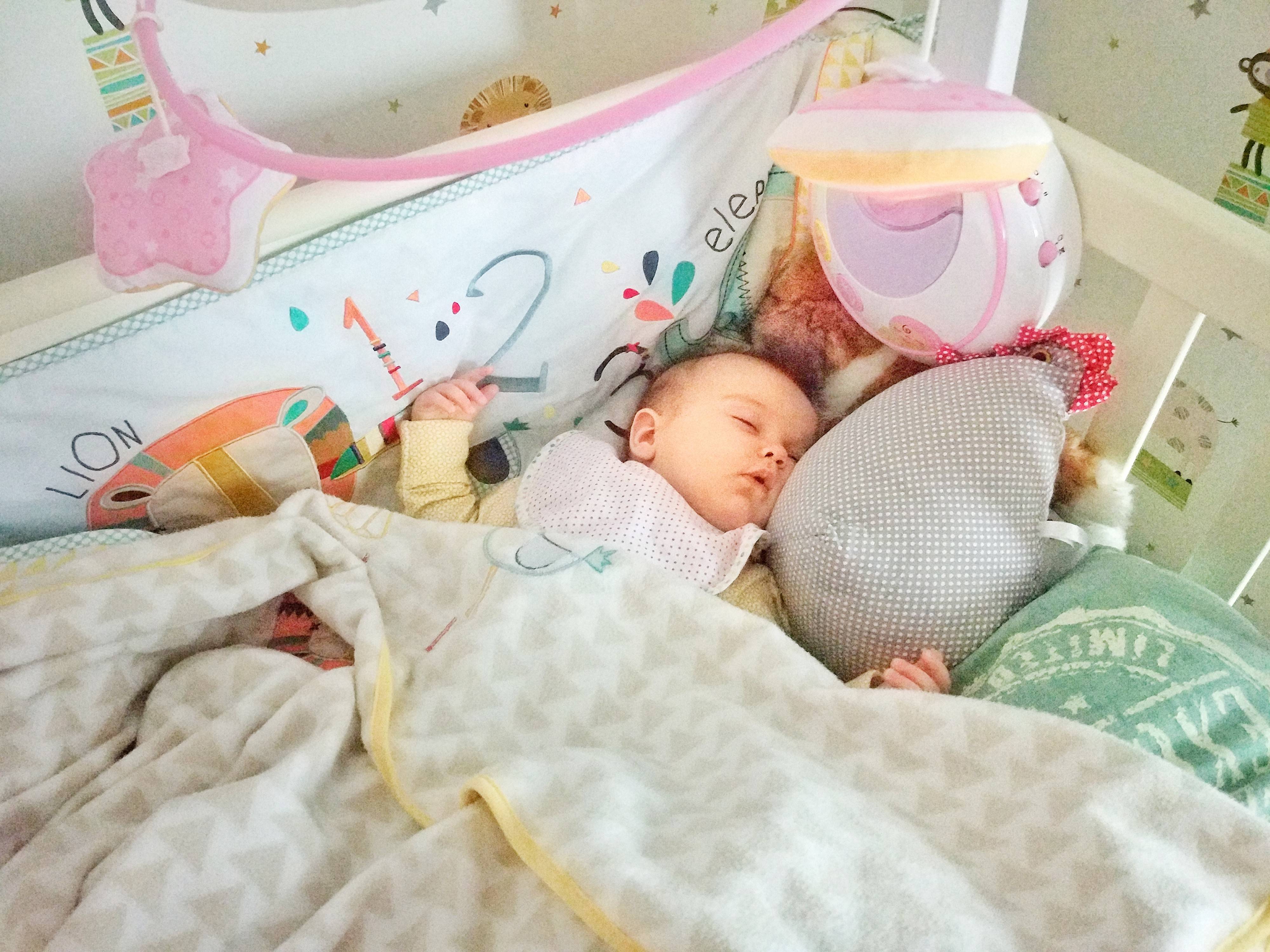 Новорожденный спит в кроватке